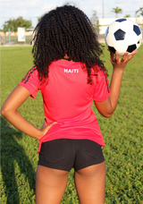 One Flag Nation™ Haitian Pride Black and Red Official Sport Jersey Back View of  Woman Standing with Soccer Ball 
